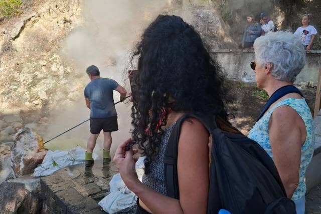 Visitor at Furnas volcano admiring a hot spring